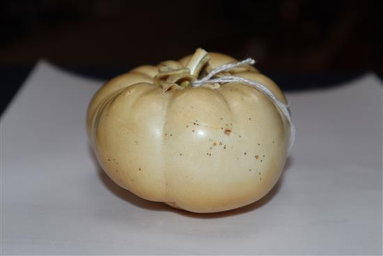 A good Japanese ivory model of a persimmon fruit, early 20th century, three character signature and seal, remnants of colouring to base